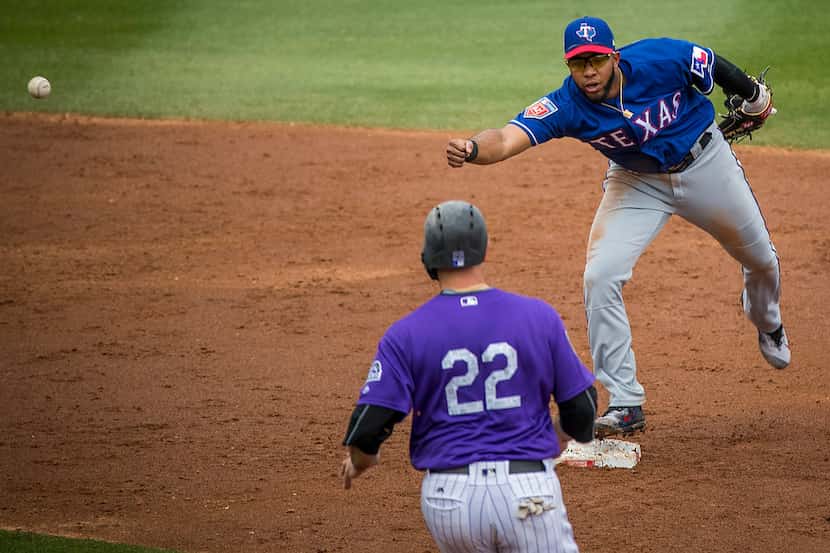 A throwing error by Texas Rangers second baseman Rougned Odor gets away from shortstop Elvis...