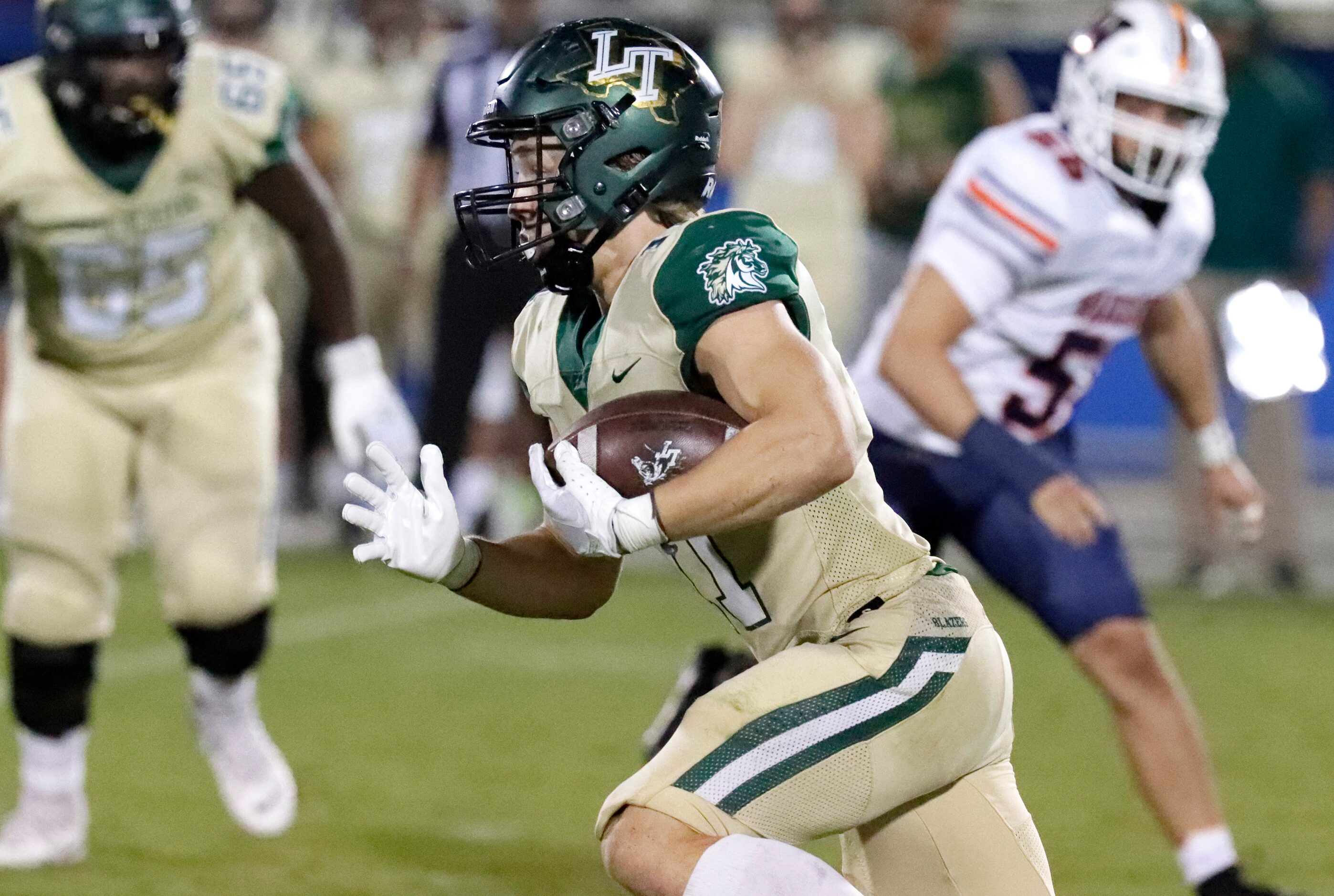 Lebanon Trail High School running back Hudson Eidem (11) carries the football during the...