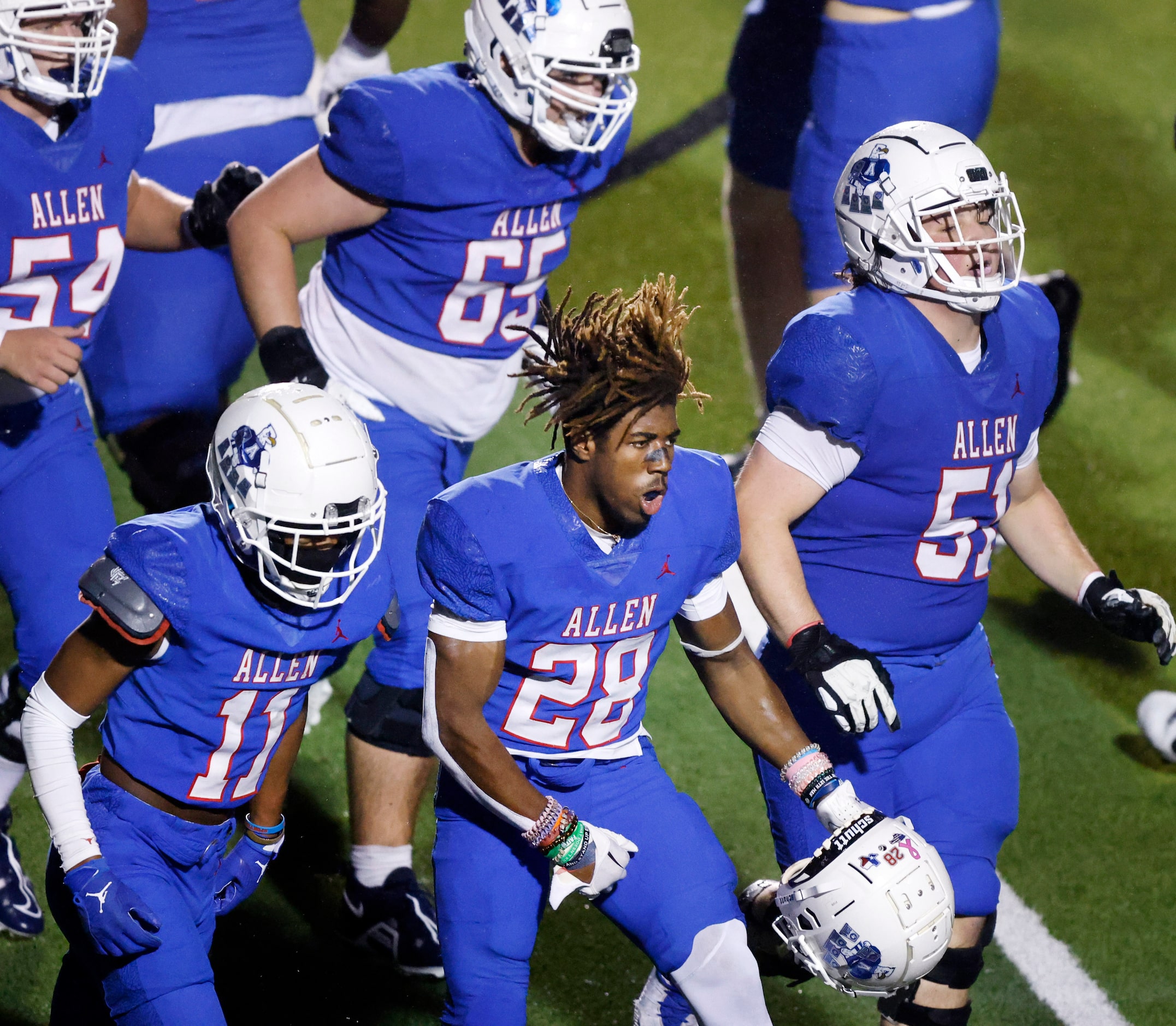 Allen running back Amir McDowell (28) celebrates his third quarter touchdown with teammates...