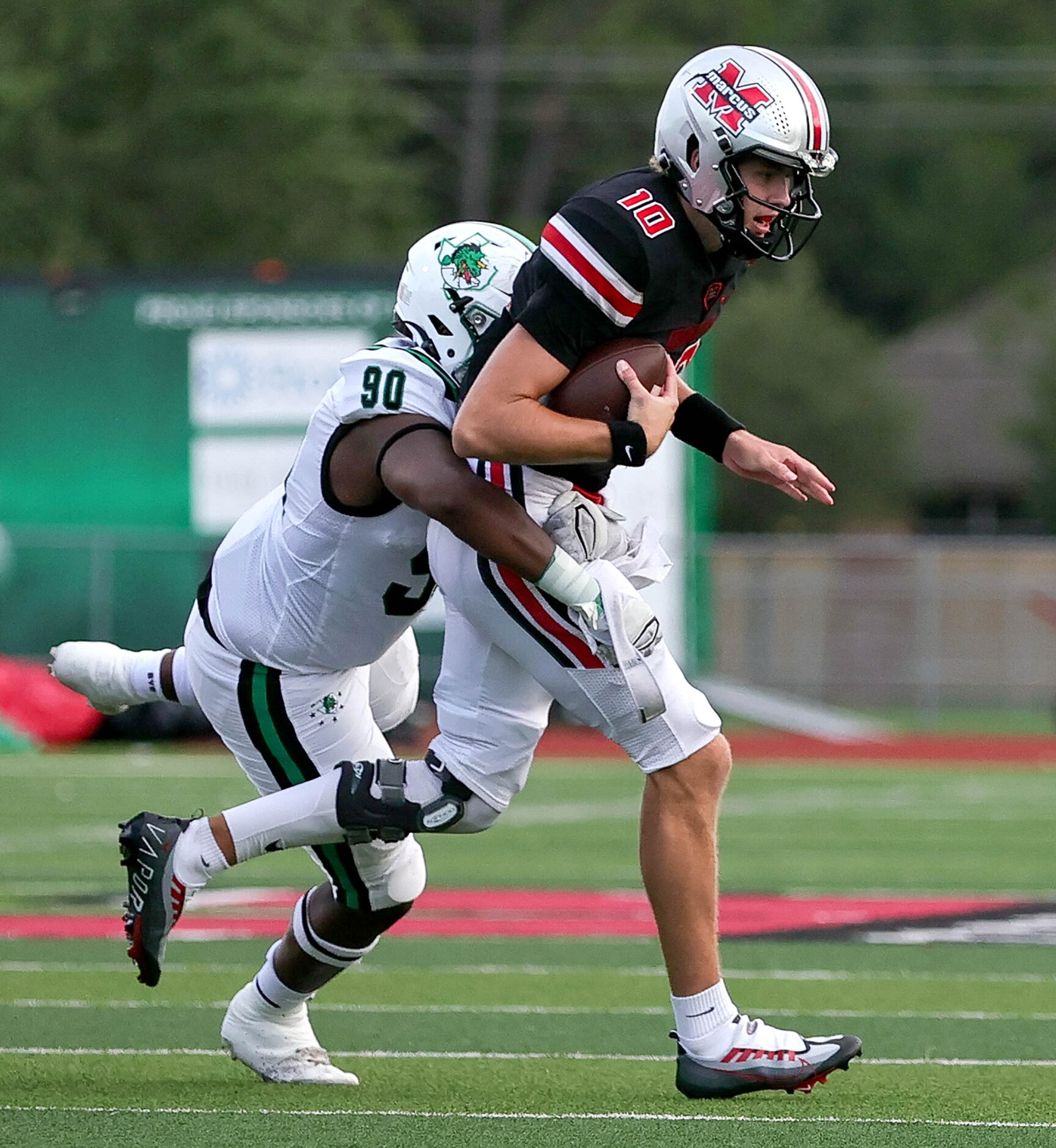 Southlake Carroll defensive lineman Kyle Middleton (90) sacks flower Mound Marcus...