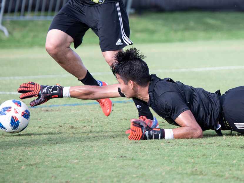 Jesse Gonzalez dives to take a ball away from an attacker during FC Dallas training. (6-12-18)