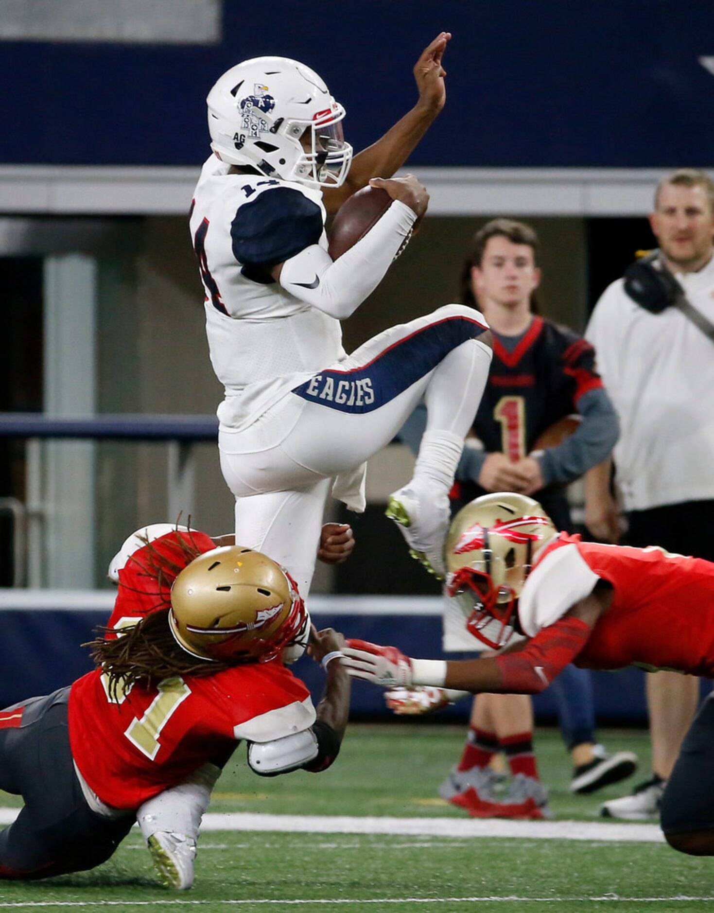 Allen quarterback Grant Tisdale (14) is tackled by South Grand Prairie's Lance Herring (31)...