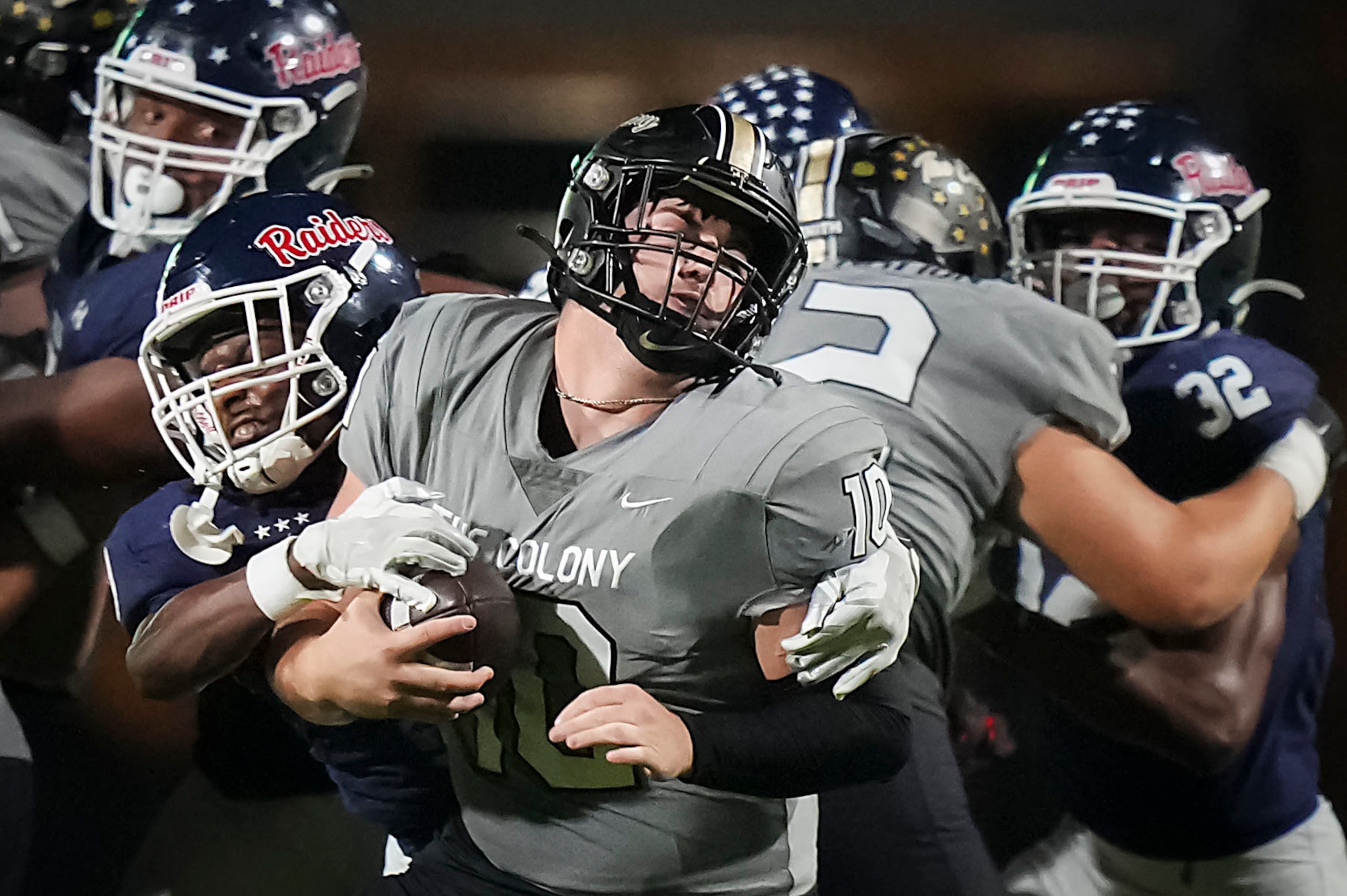 The Colony quarterback Carson Cox (10) is brought down by Denton Ryan defensive back Elijah...