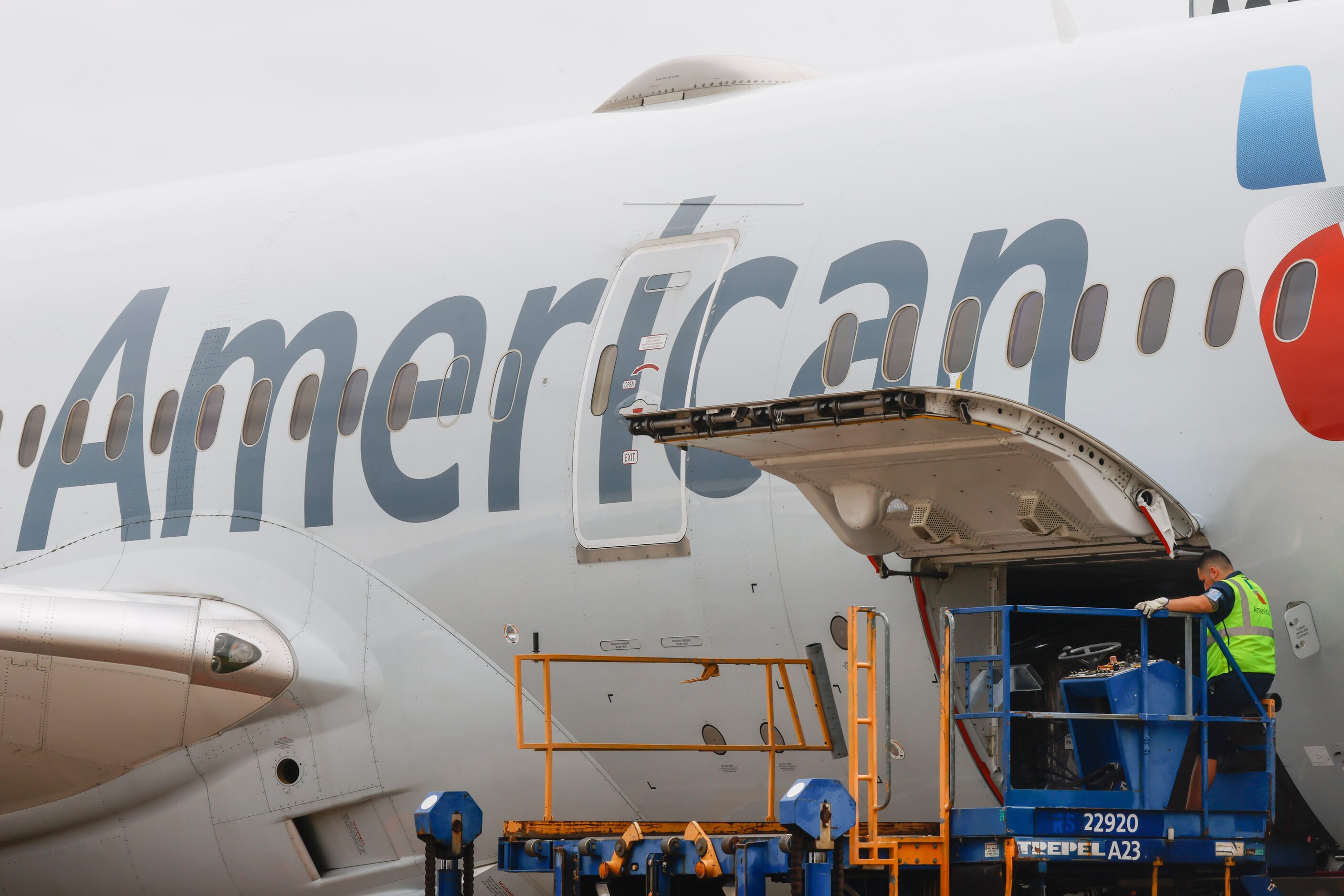 Members of the ground crew work on an American Airlines flight on Tuesday, May 9, 2023 at...