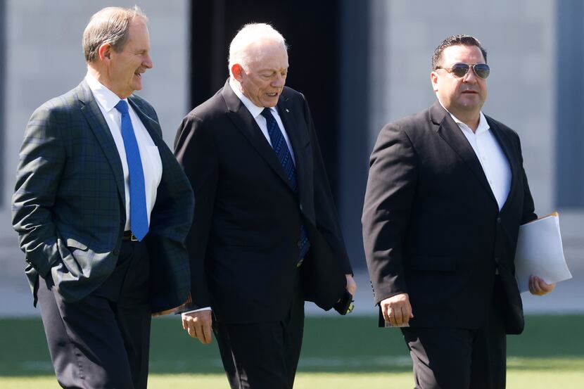 Dallas Cowboys Owner Jerry Jones, center, walks in to the field during a practice session at...