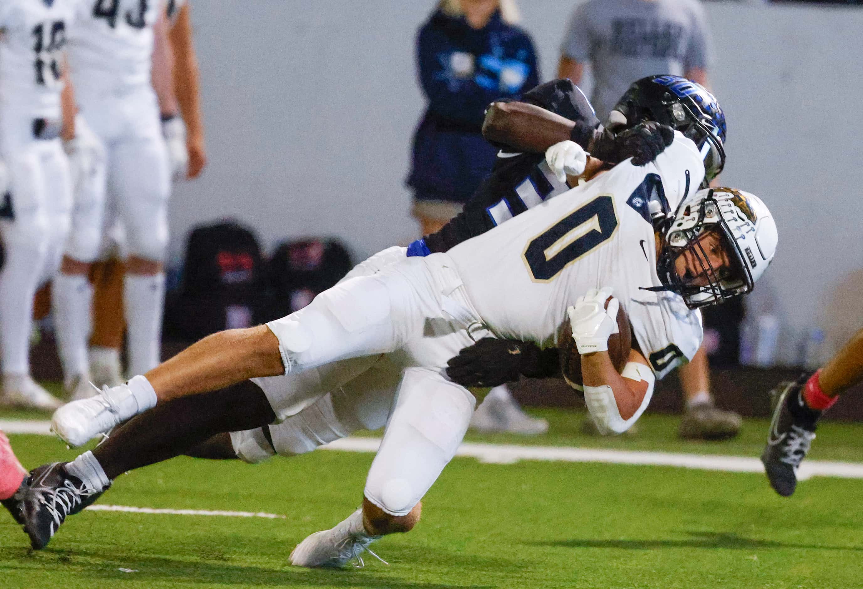 Byron Nelson high’s Jacoven Julian (back) tackles Keller High’s Kyle Owens during the first...