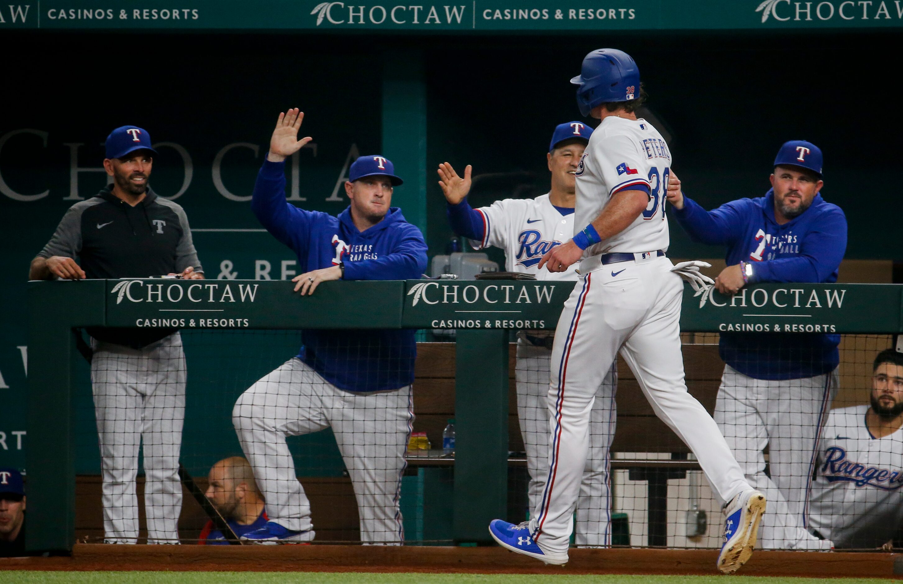 Texas Rangers center fielder DJ Peters (38) celebrates after running to home following Texas...