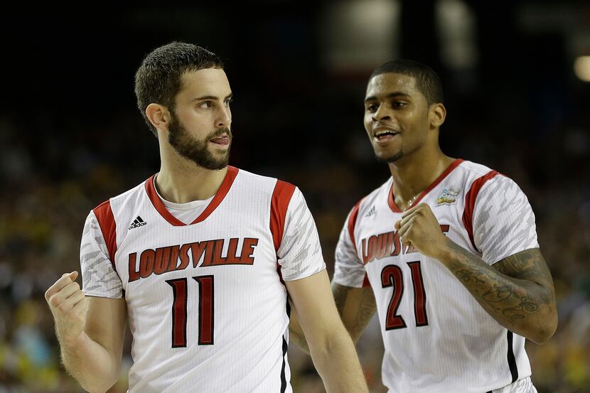 Louisville's Luke Hancock, left, and Louisville's Chane Behanan react to play against...