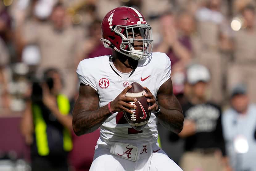 Alabama quarterback Jalen Milroe (4) looks to pass down field during the first half of an...