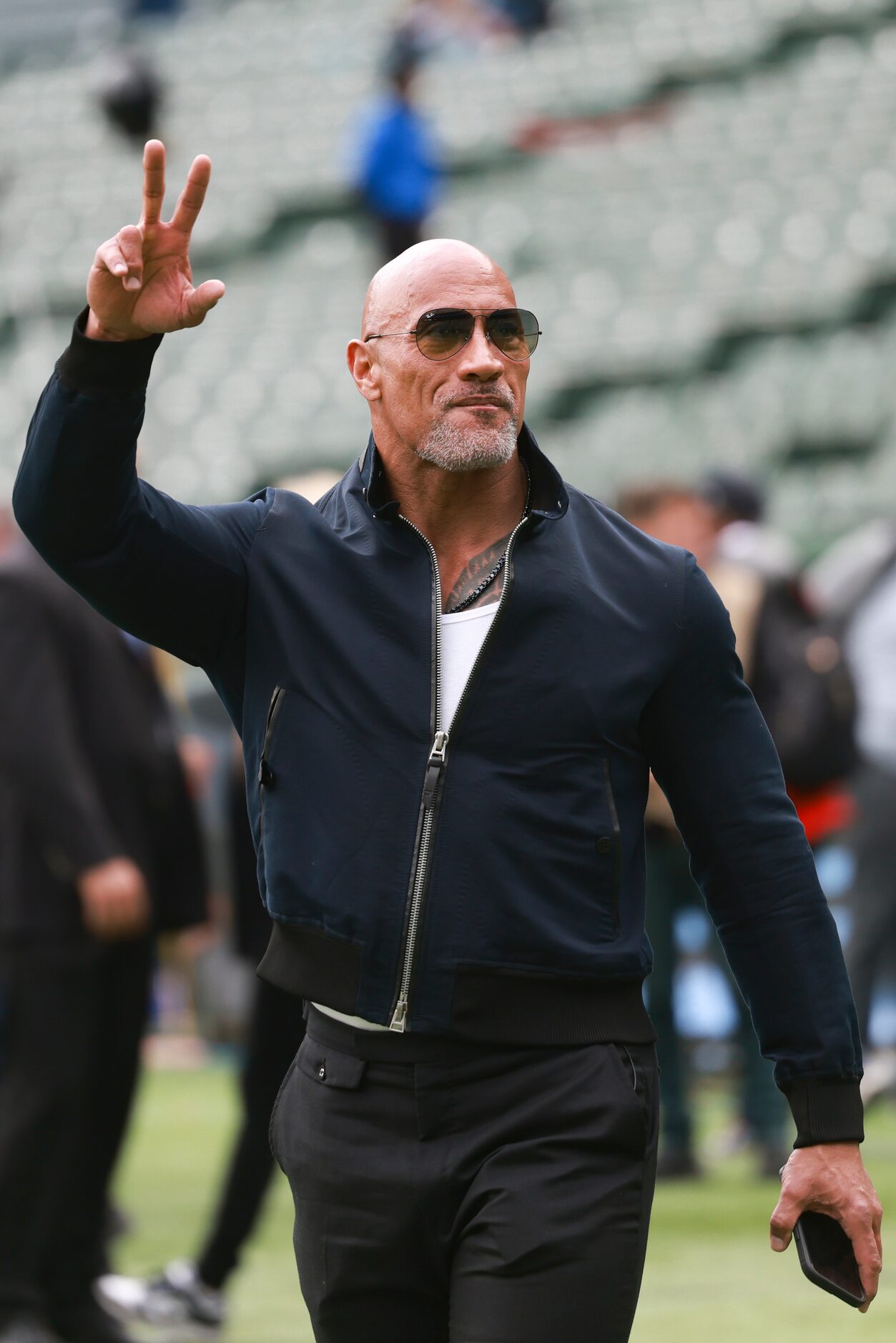 Dwayne “The Rock” Johnson waves to the crowd before an XFL football game between the...