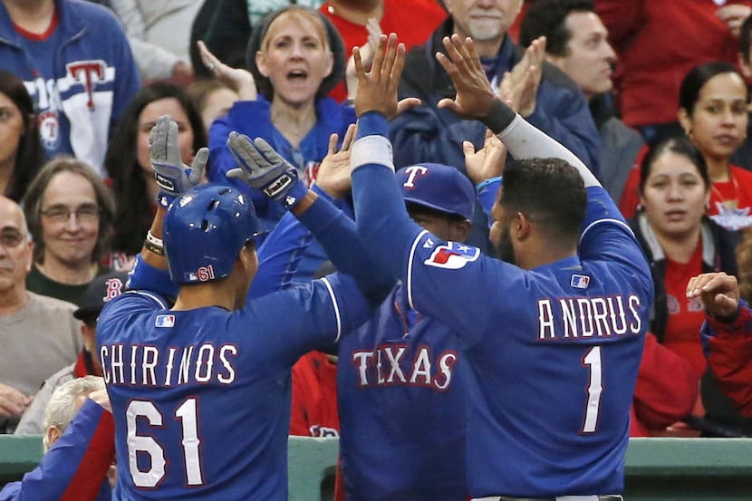 Texas Rangers' Robinson Chirinos (61) celebrates his solo home run with teammates at the...