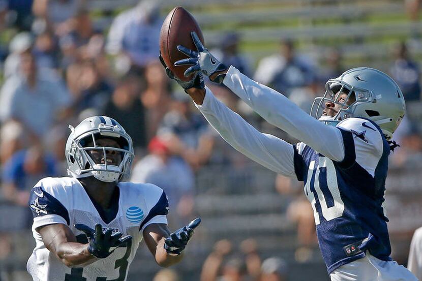 Cowboys cornerback Charvarius Ward (40) intercepts a pass intended for wide receiver Michael...