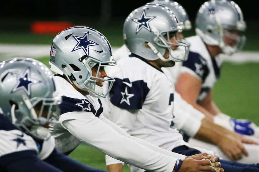 Dallas Cowboys quarterback Dak Prescott (4) stretches during the Dallas Cowboys practice at...