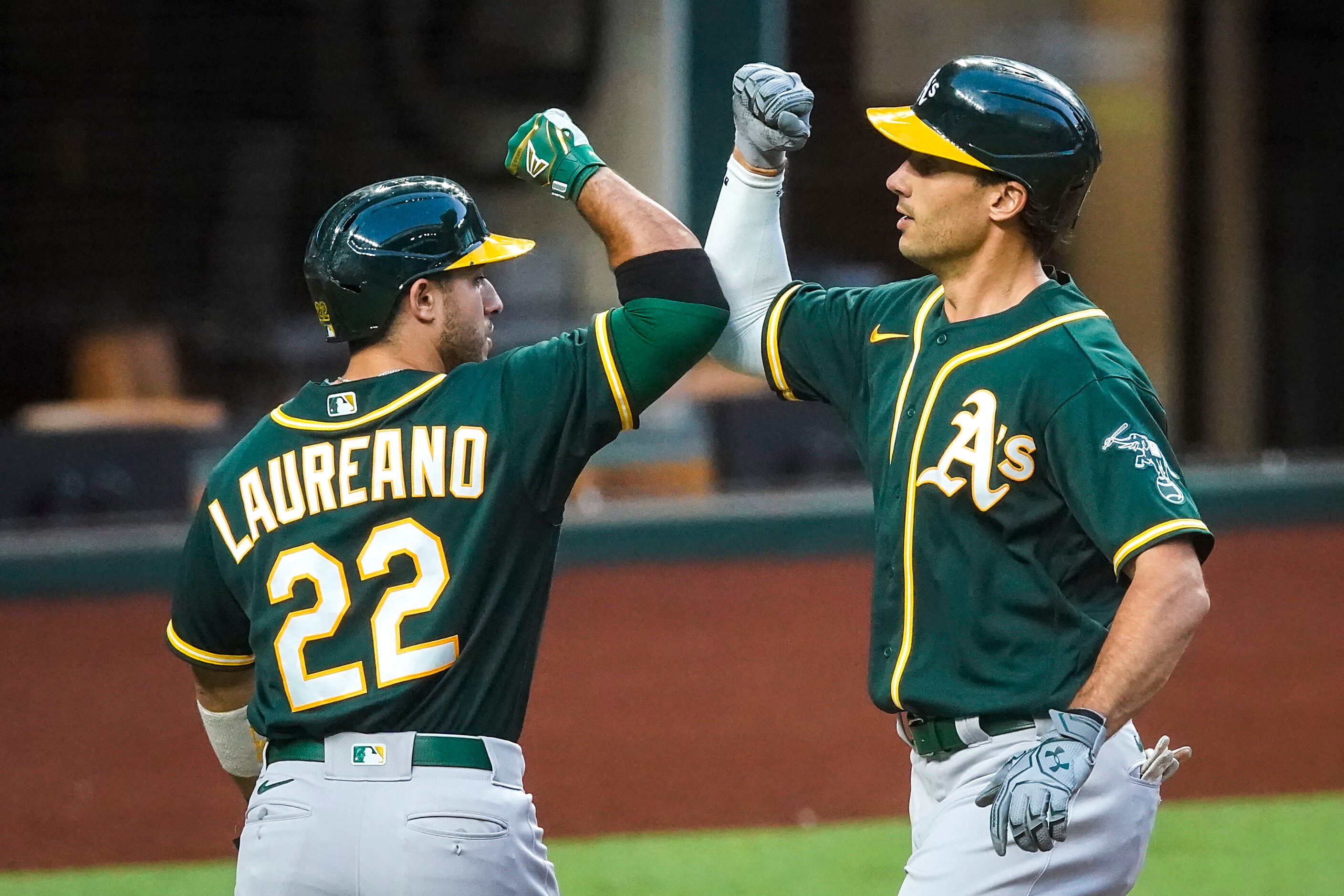 Oakland Athletics first baseman Matt Olson celebrates with center fielder Ramon Laureano...