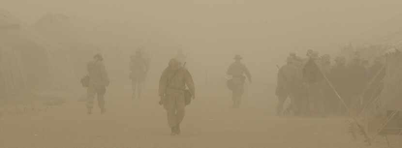 CAMP SHOUP, KUWAIT - U.S. Marines of Task Force Tarawa walk through a dust storm at Camp...