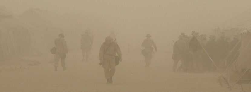 CAMP SHOUP, KUWAIT - U.S. Marines of Task Force Tarawa walk through a dust storm at Camp...