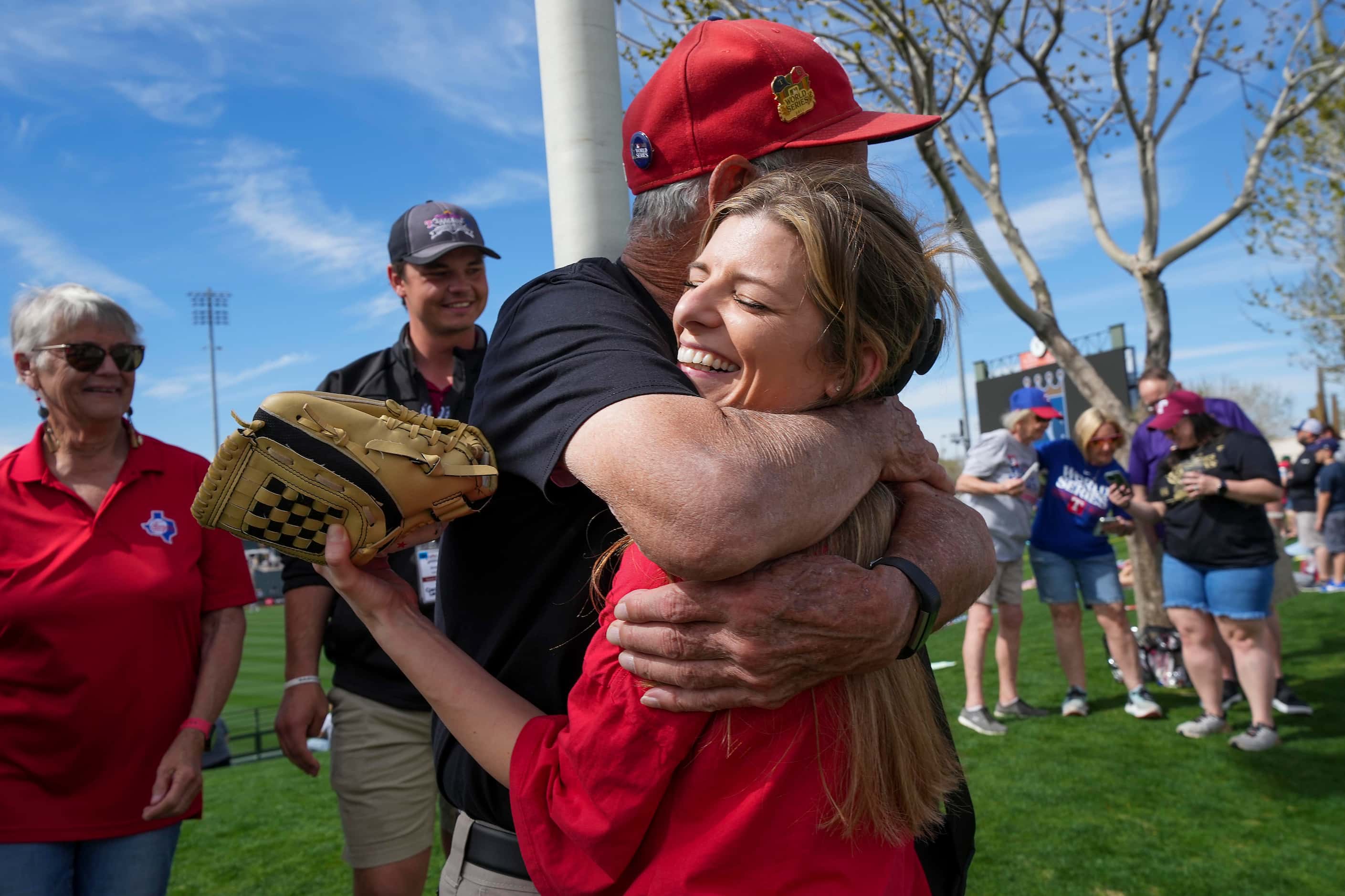 Lindsey Doss, a former member of the Texas Rangers Six Shooters Squad, hugs Cal Kost, a...