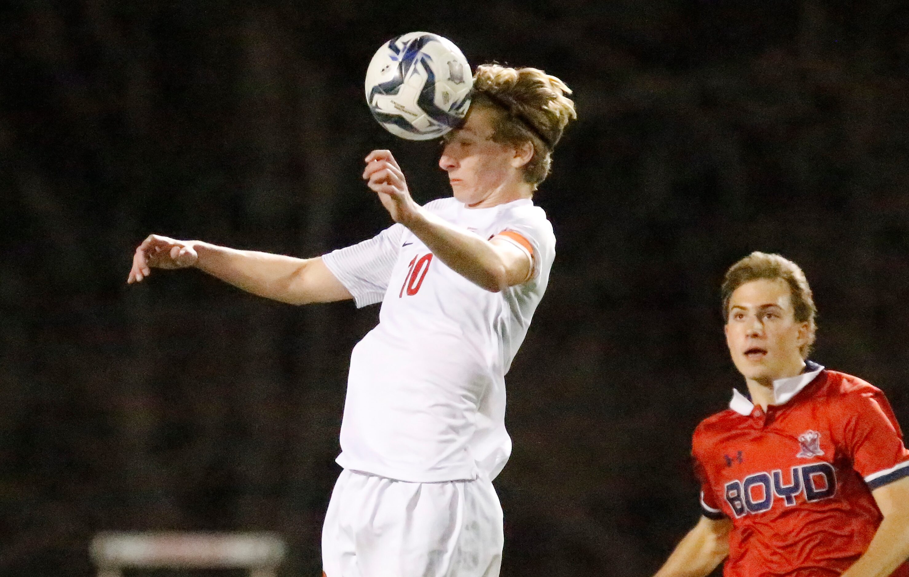 Allen High School midfielder Evan Pustejovsky (10) gets a header during the first half as...