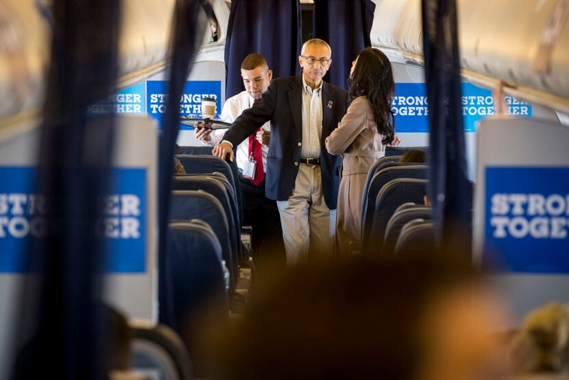 Hillary Clinton campaign chair John Podesta speaks to top Clinton aide Huma Abedin en route...