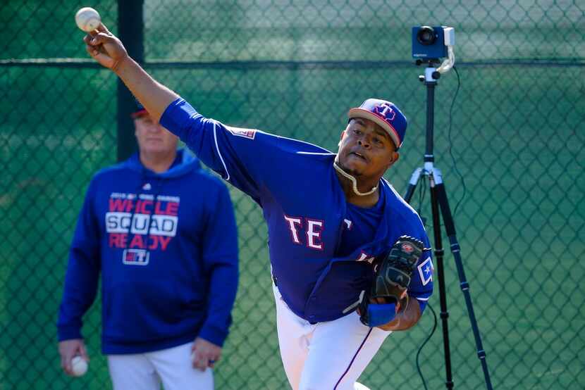 Texas Rangers pitcher Edinson Volquez throws in the bullpen during a spring training workout...