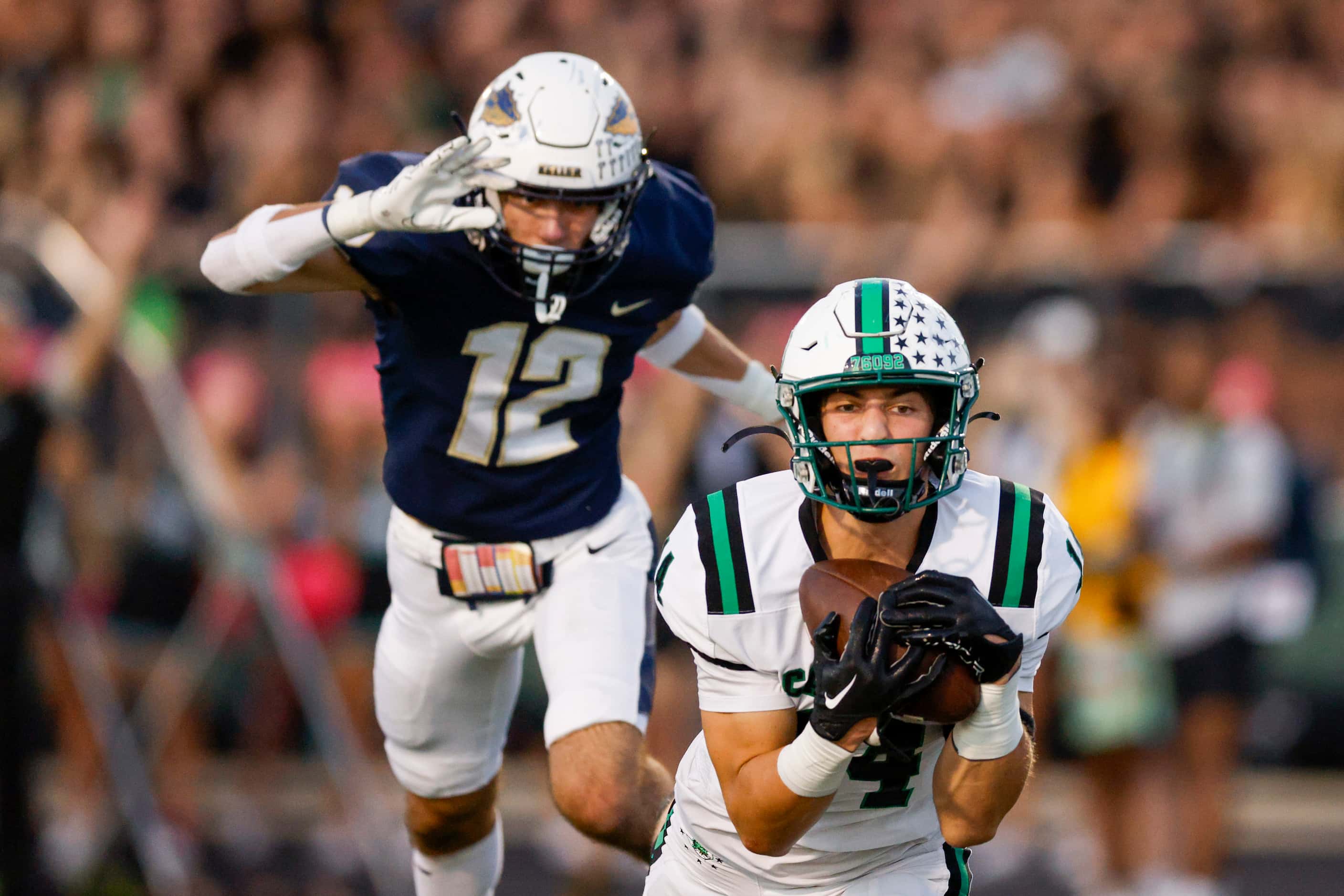 Southlake Carroll wide receiver Clayton Wayland (14) makes a diving catch ahead of Keller...
