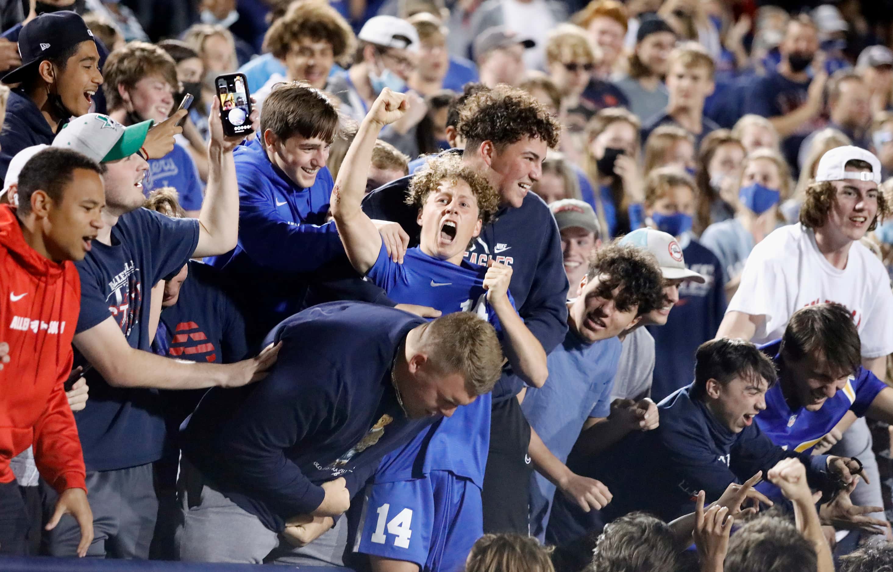 Allen forward Matthew Sanchez (14) leaps into the student section to celebrate making his...