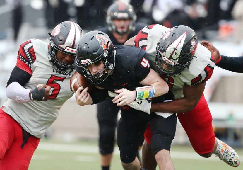 Mansfield Legacy defensive back Jalen Catalon (5) strips the ball from Aledo quarterback...