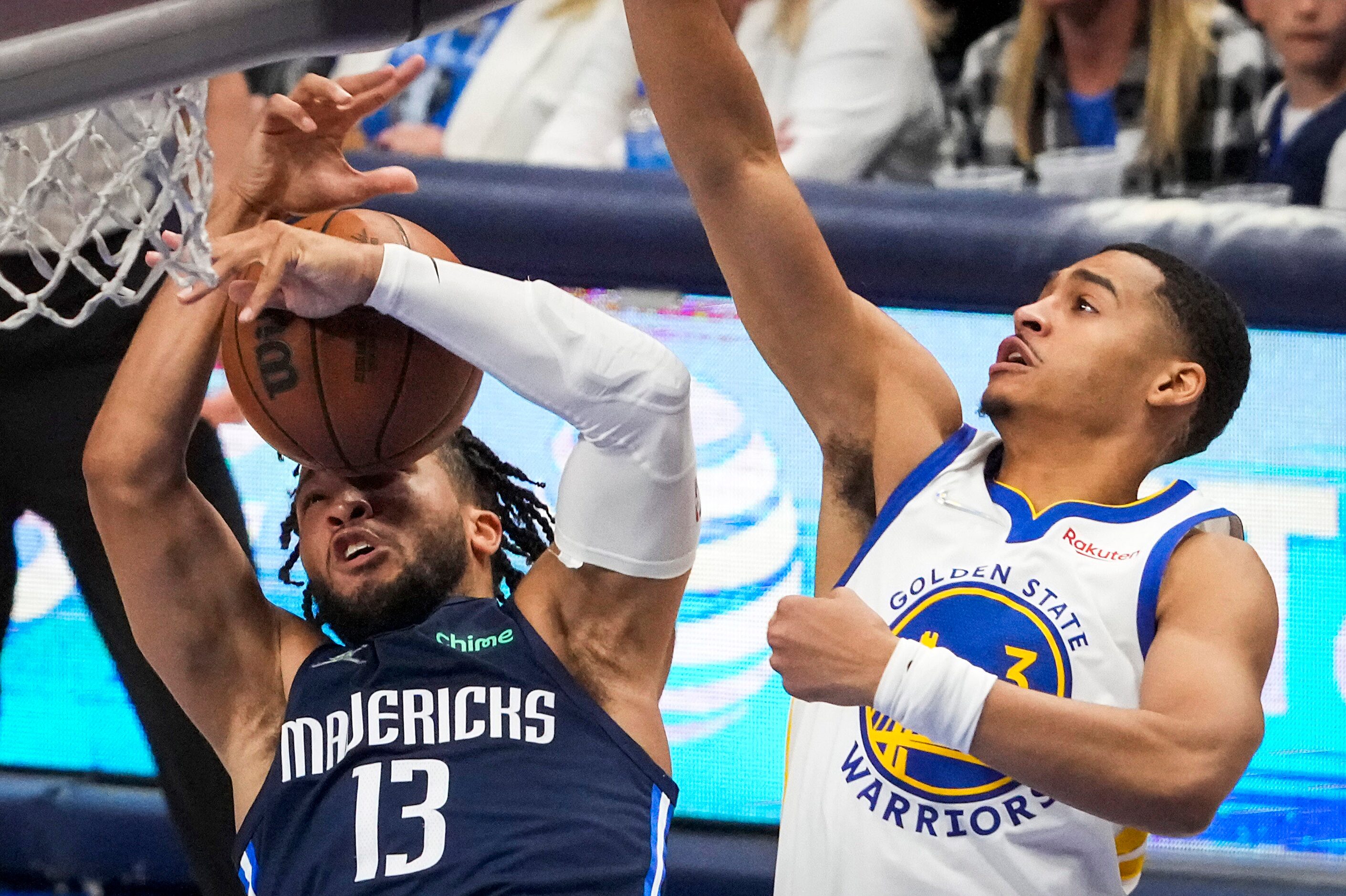 Dallas Mavericks guard Jalen Brunson (13) fights for a rebound against Golden State Warriors...