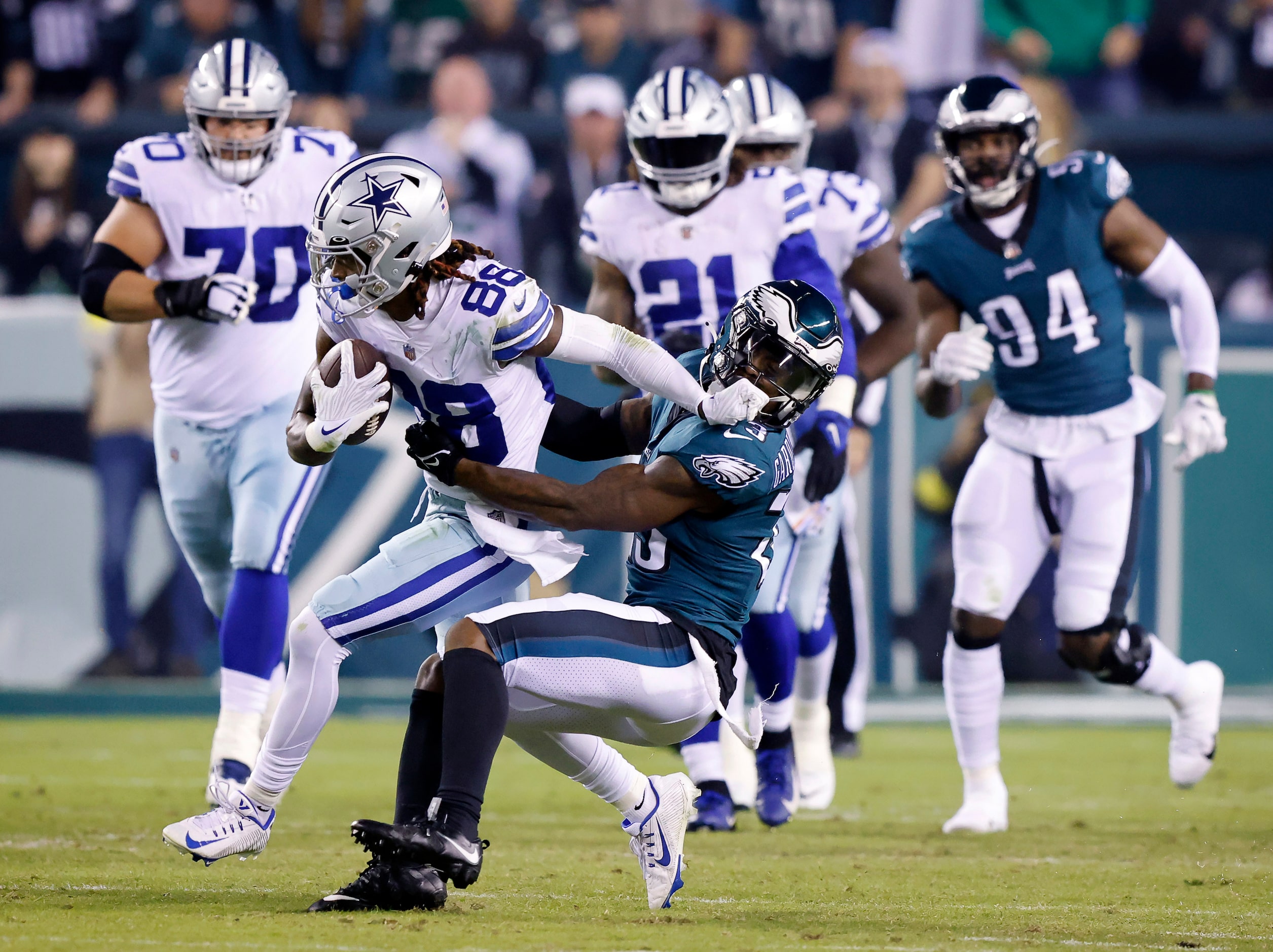 Dallas Cowboys wide receiver CeeDee Lamb (88) stiff arms Philadelphia Eagles safety C.J....