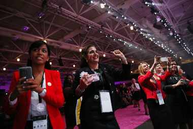 Guests cheer as Mary Kay salespeople spouses walk across the stage during the annual Mary...