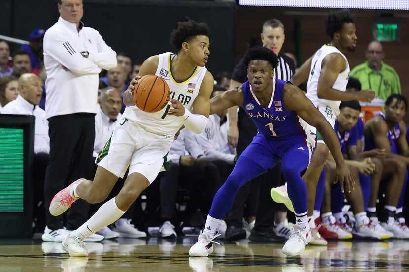 Baylor guard Keyonte George, front left, drives the ball against Kansas guard Joseph Yesufu,...