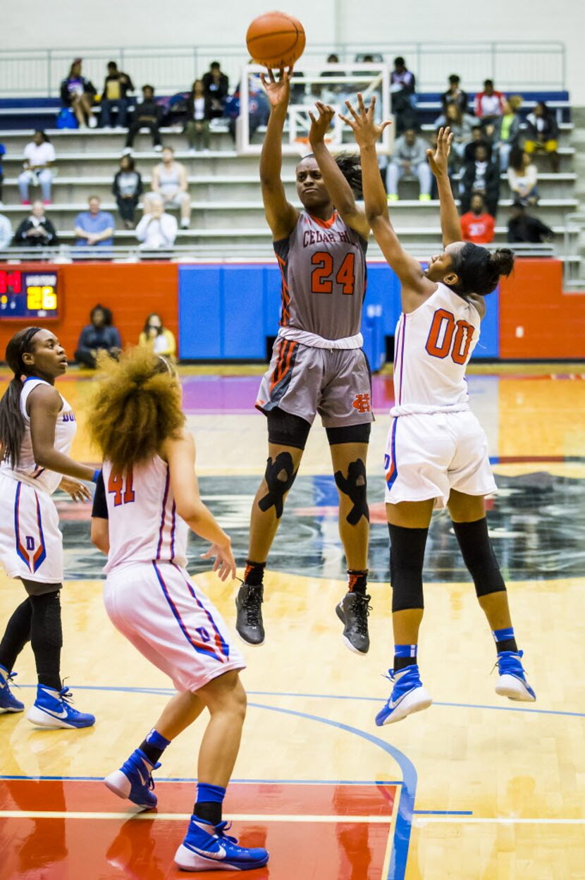 Cedar Hill's Joyner Holmes (24) puts up a shot as Duncanville's Zarielle Green (00) defends...