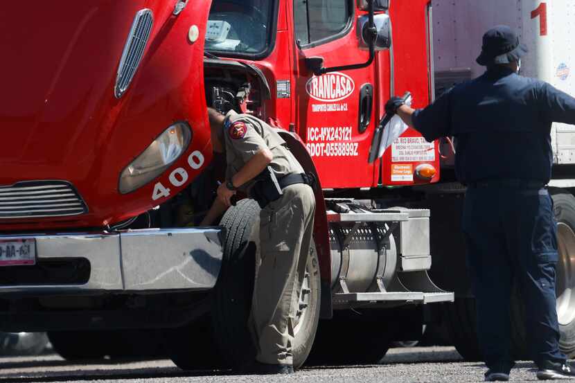 Texas state troopers resume the inspection of trucks following the end of a blockade by...