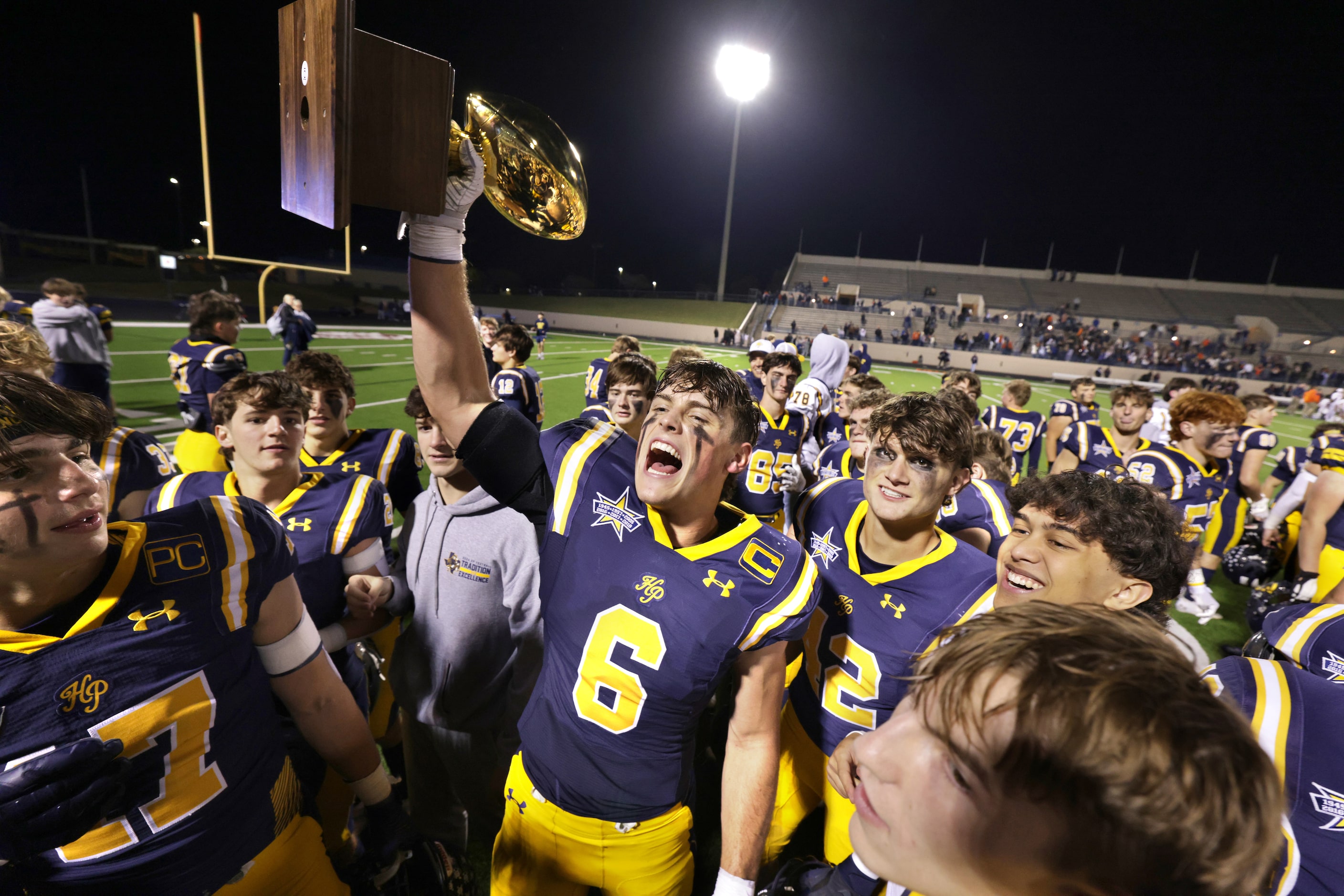 Highland Park players celebrate after winning a football playoff game against Frisco...