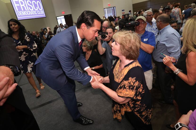 Presidential candidate Julian Castro, left, speaks with Jessica Moore at the Collin College...