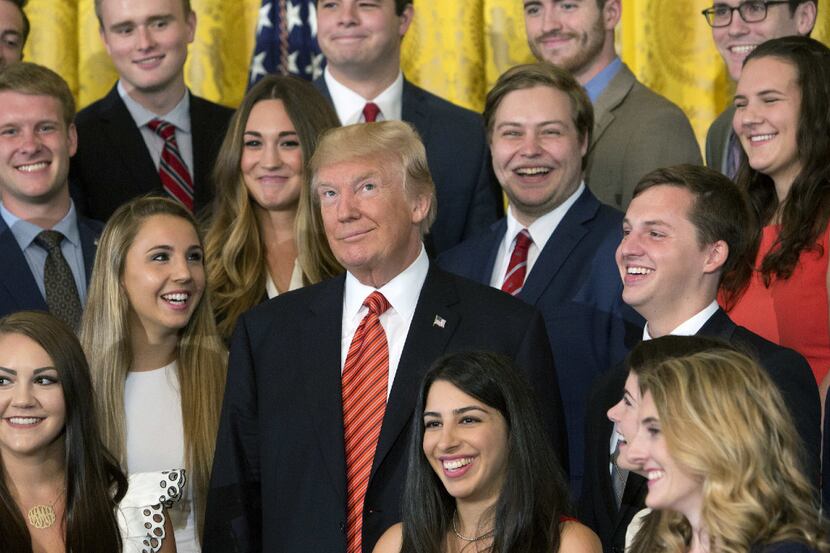 U.S. President Donald J. Trump poses for photographs with an outgoing group of interns at...