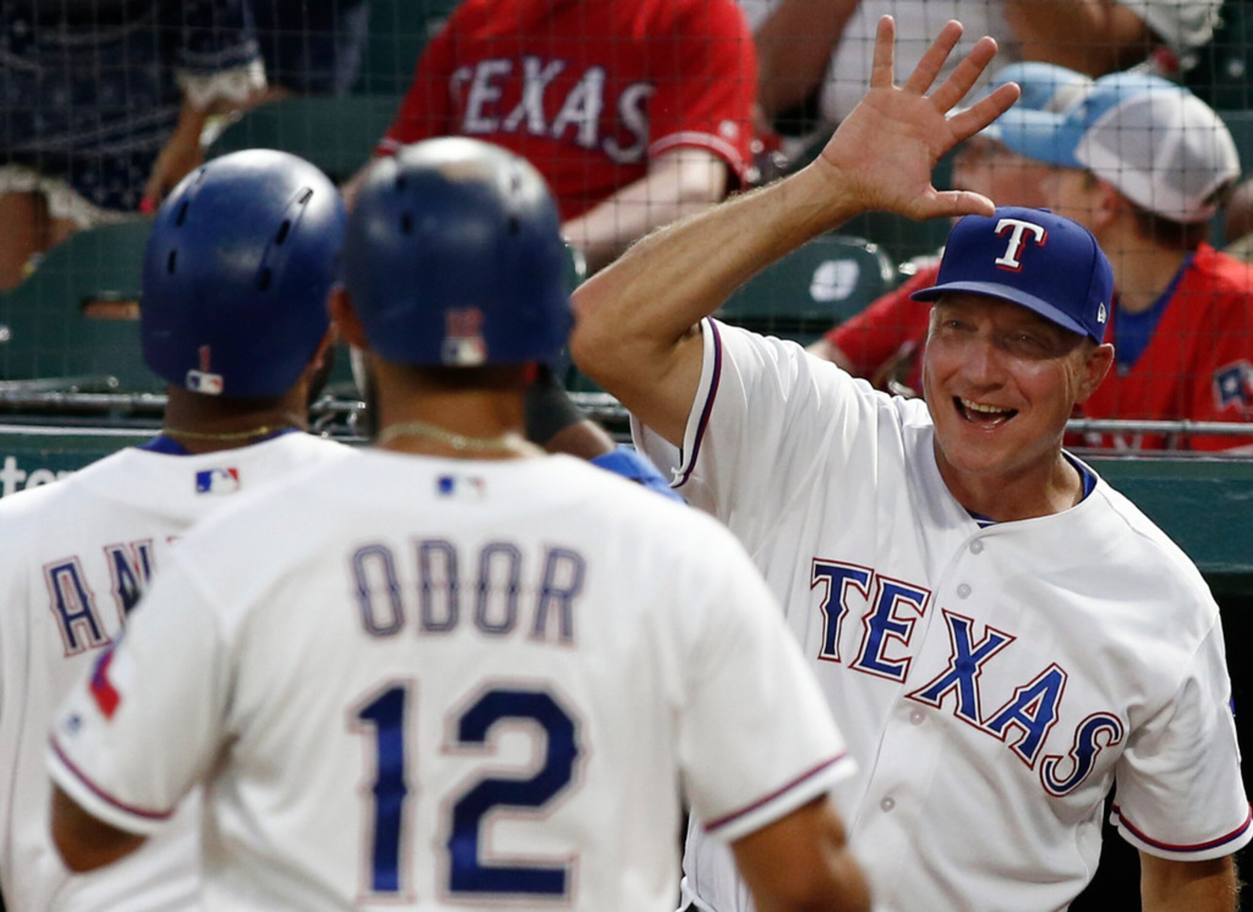 Texas Rangers manager Jeff Banister, on right, congratulates Elvis Andrus after he hit a...