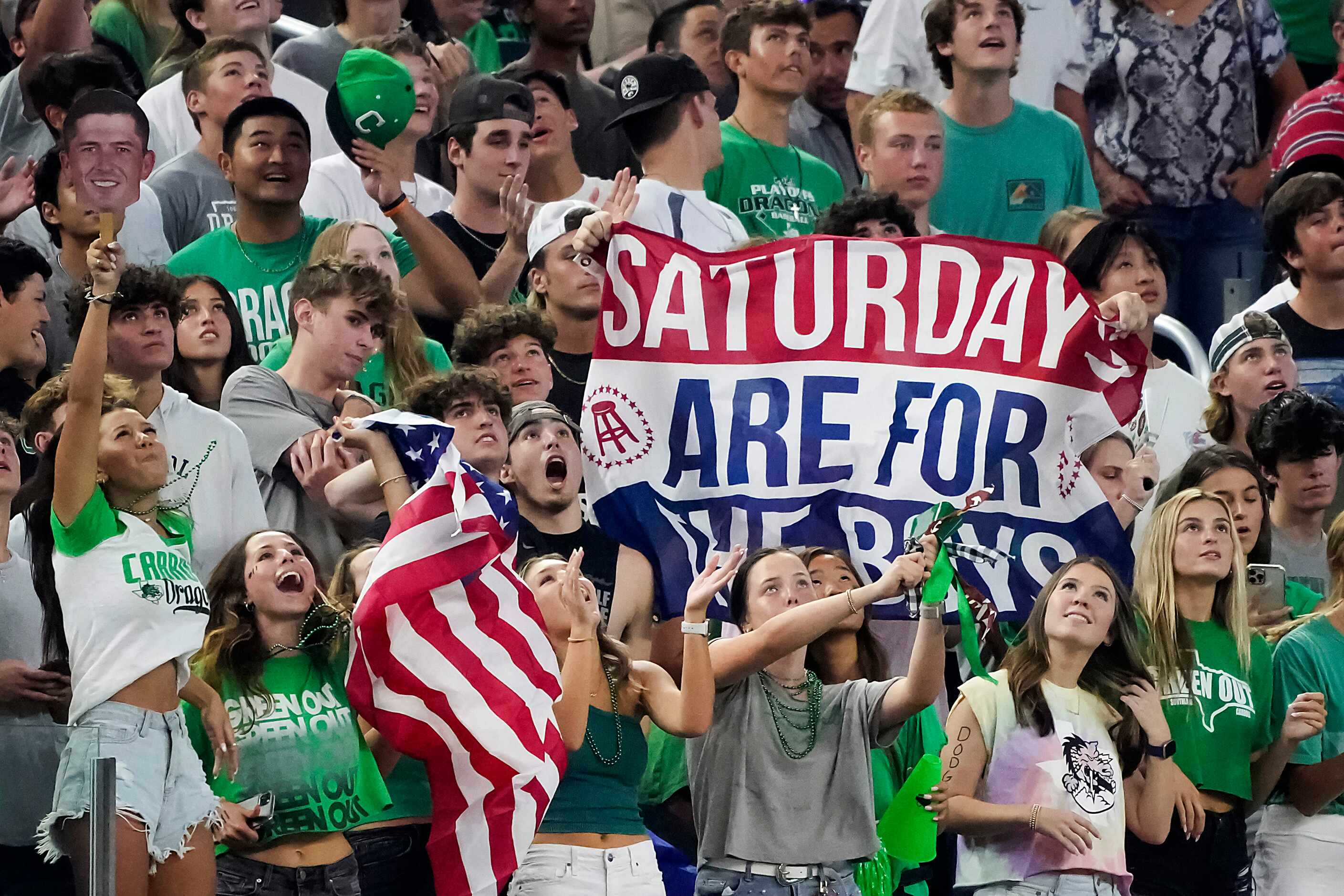 Southlake Carroll fans cheer their team during the first half of a high school football game...