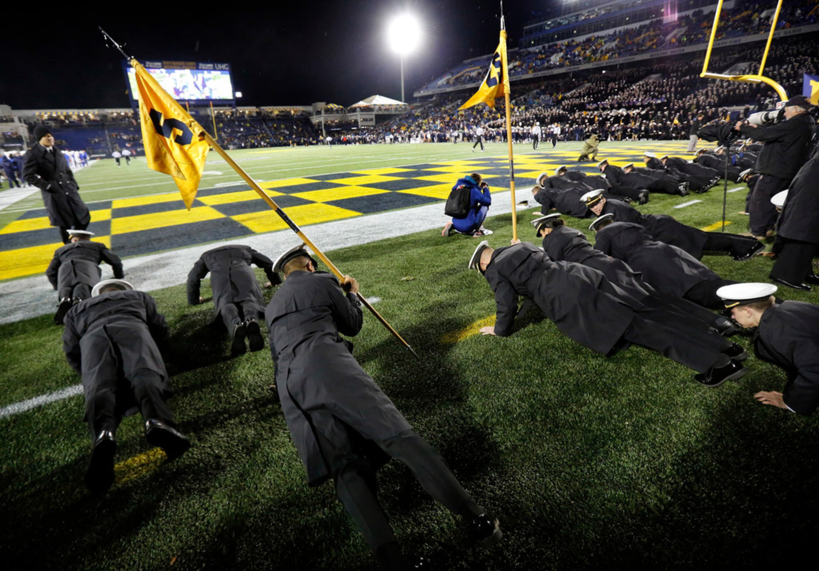 The Navy Midshipmen do pushups in the ned zone after a fourth quarter touchdown against the...