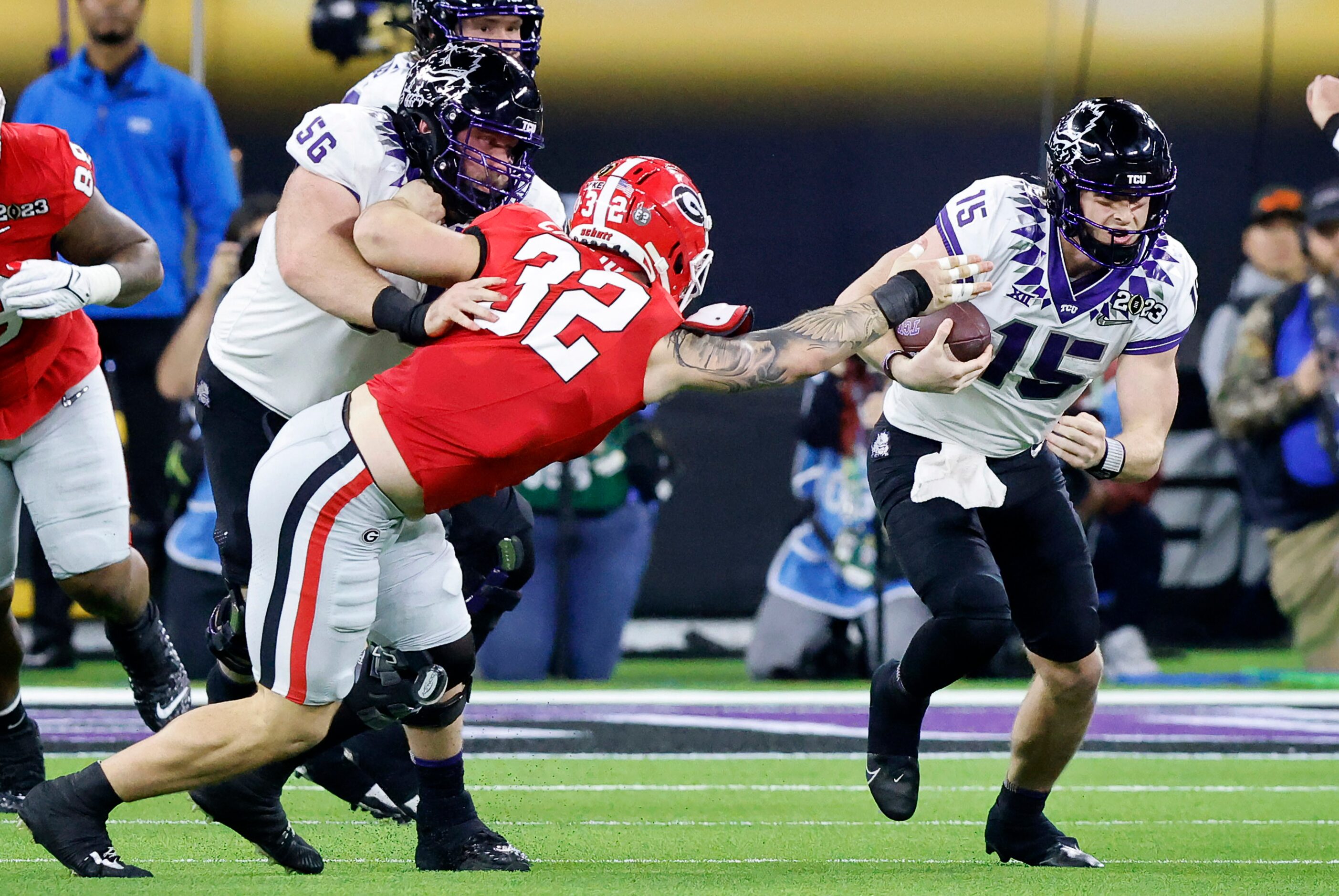 TCU Horned Frogs quarterback Max Duggan (15) keeps the ball and runs as Georgia Bulldogs...