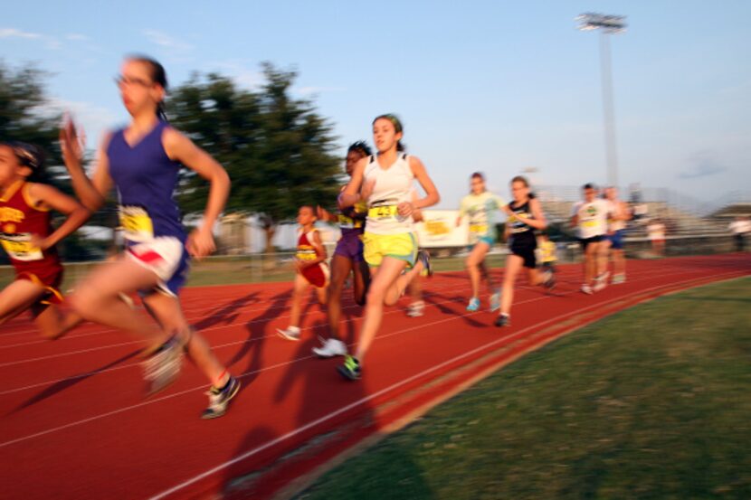 Ann Gehan, 13, of Dallas, center, competes in the 400 meter race during the 29th annual...