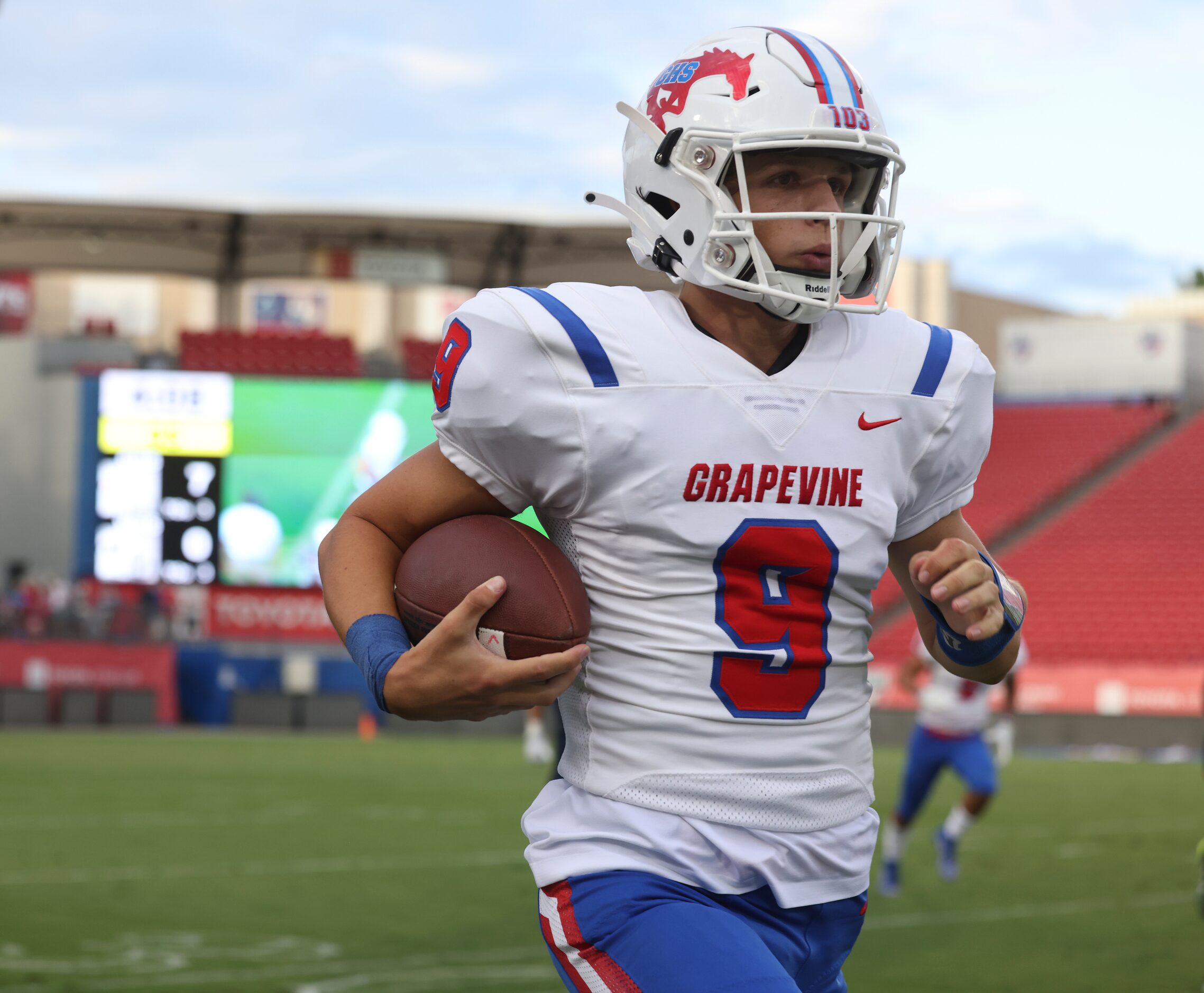 Grapevine High School’s quarterback Evan Baum (9) runs the ball up the field in the first...