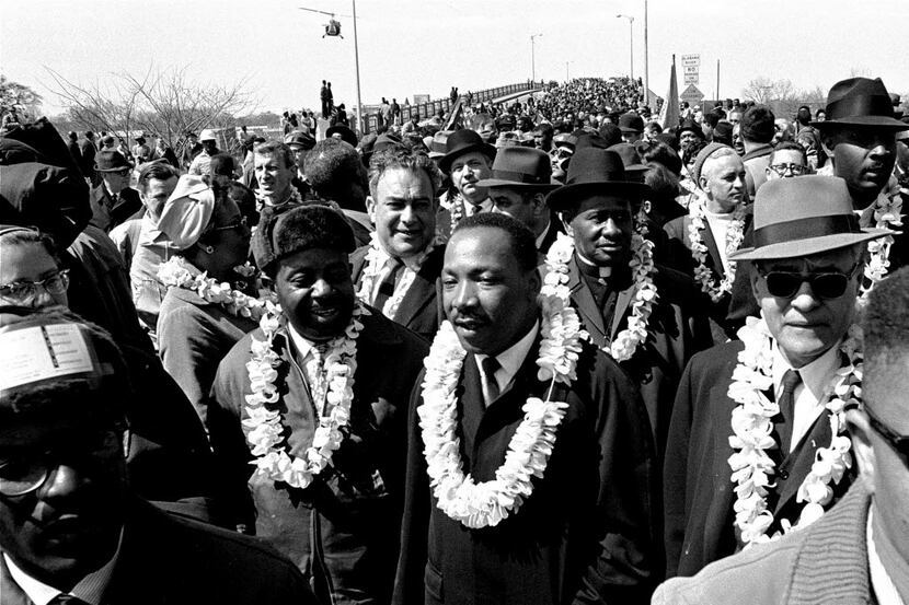 FILE - In this March 21, 1965 file photo, Martin Luther King, Jr. and his civil rights...