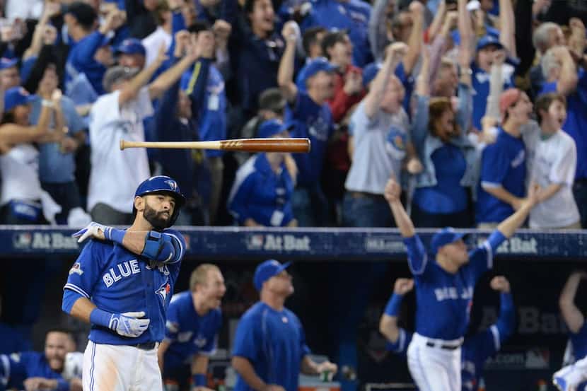 Toronto Blue Jays' Jose Bautista tosses his bat after hitting a three-run home run during...