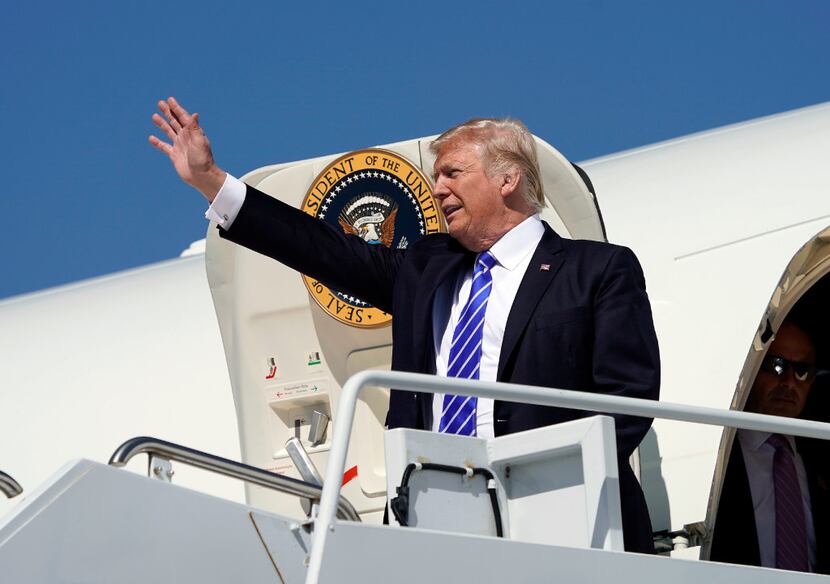 President Donald Trump waves during his arrival at Bismark Municipal Airport on Wednesday....