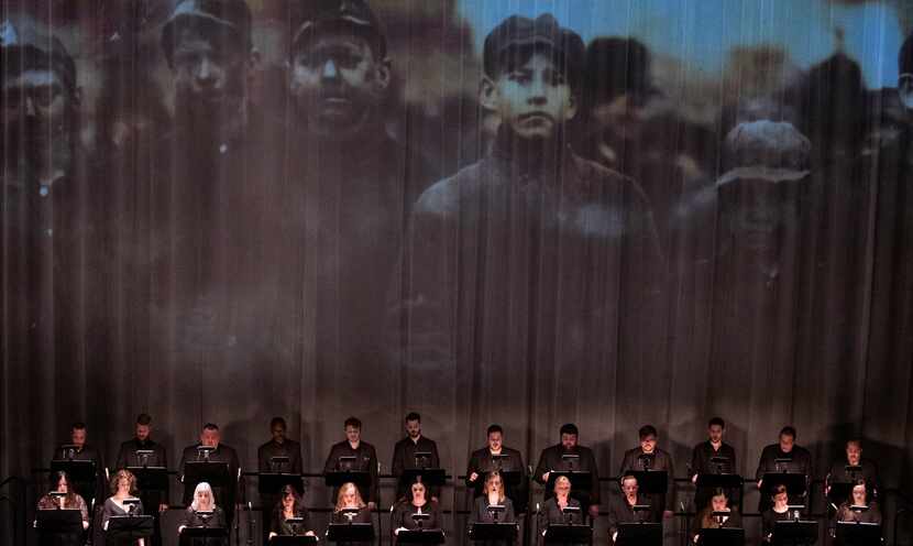 A photo of young coal miners is projected during the Verdigris Ensemble performance of Julia...