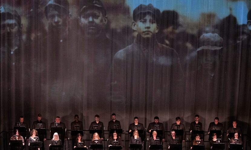 A photo of young coal miners is projected during the Verdigris Ensemble performance of Julia...