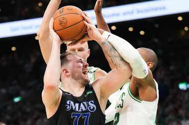 Dallas Mavericks guard Luka Doncic (77) drives to the basket against Boston Celtics center...