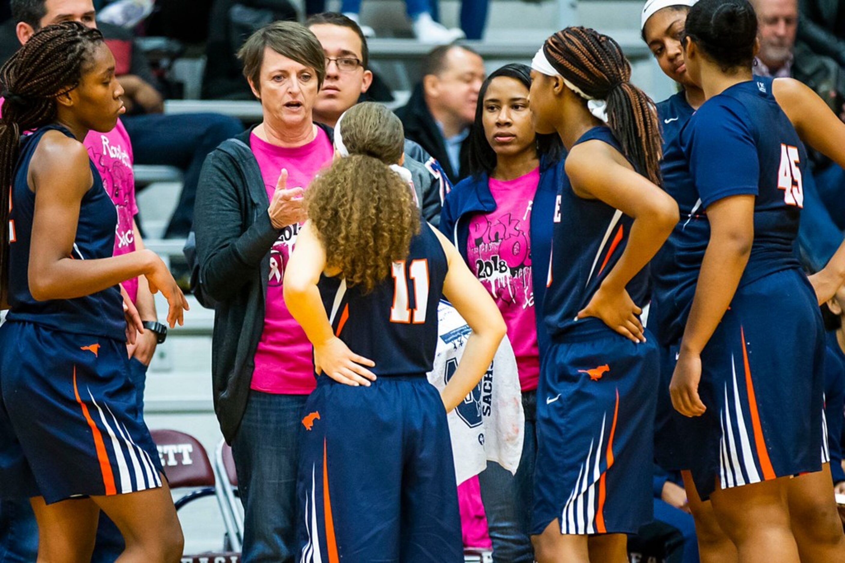 Sachse players huddle around head coach Donna McCullough during a timeout during in a...