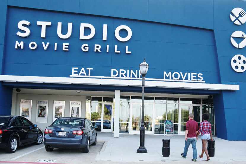 Moviegoers head into Studio Movie Grill in Arlington, Texas, on Aug. 31, 2017. The...